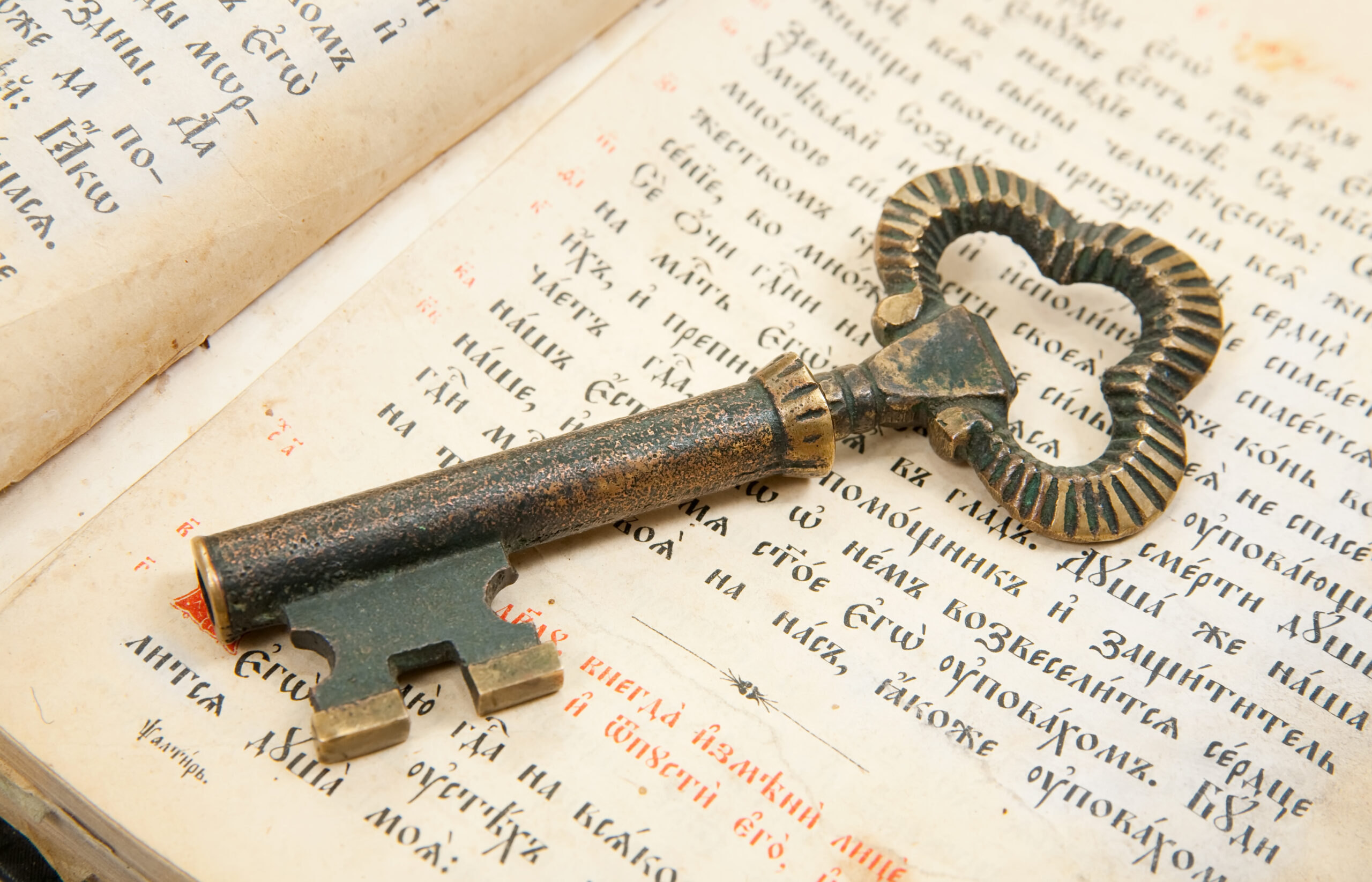 Background of Closeup of key placed on an 18st century vintage bible