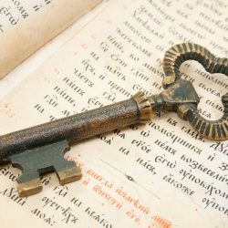 Background of Closeup of key placed on an 18st century vintage bible