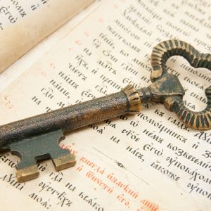 Background of Closeup of key placed on an 18st century vintage bible